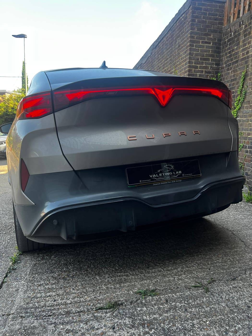 Cupra rear before valeting, flat and dusty in the shade