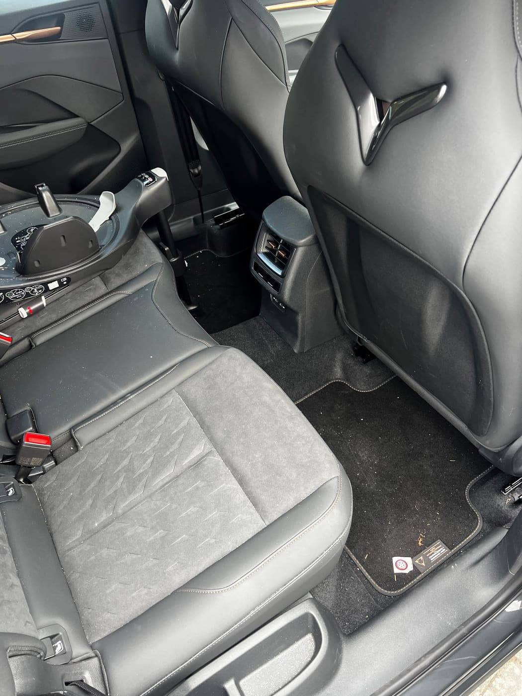 Cupra rear seats before cleaning, crumbs and debris on the carpet