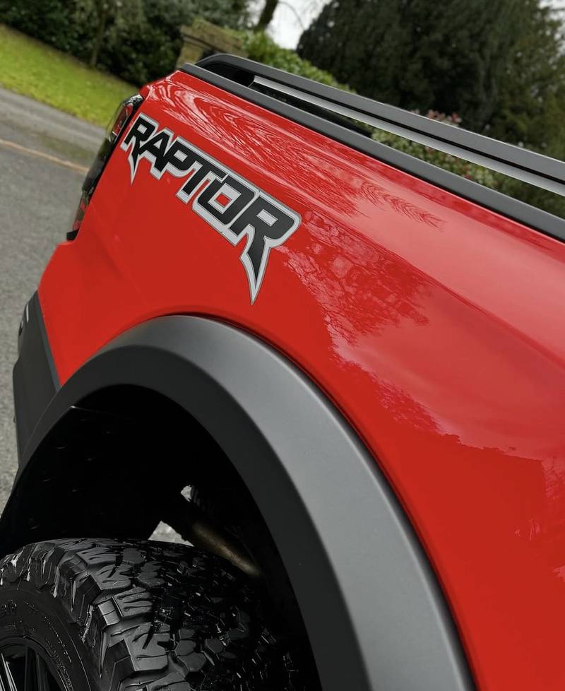 Deep gloss on the red paintwork of a Ford Raptor pickup after valeting